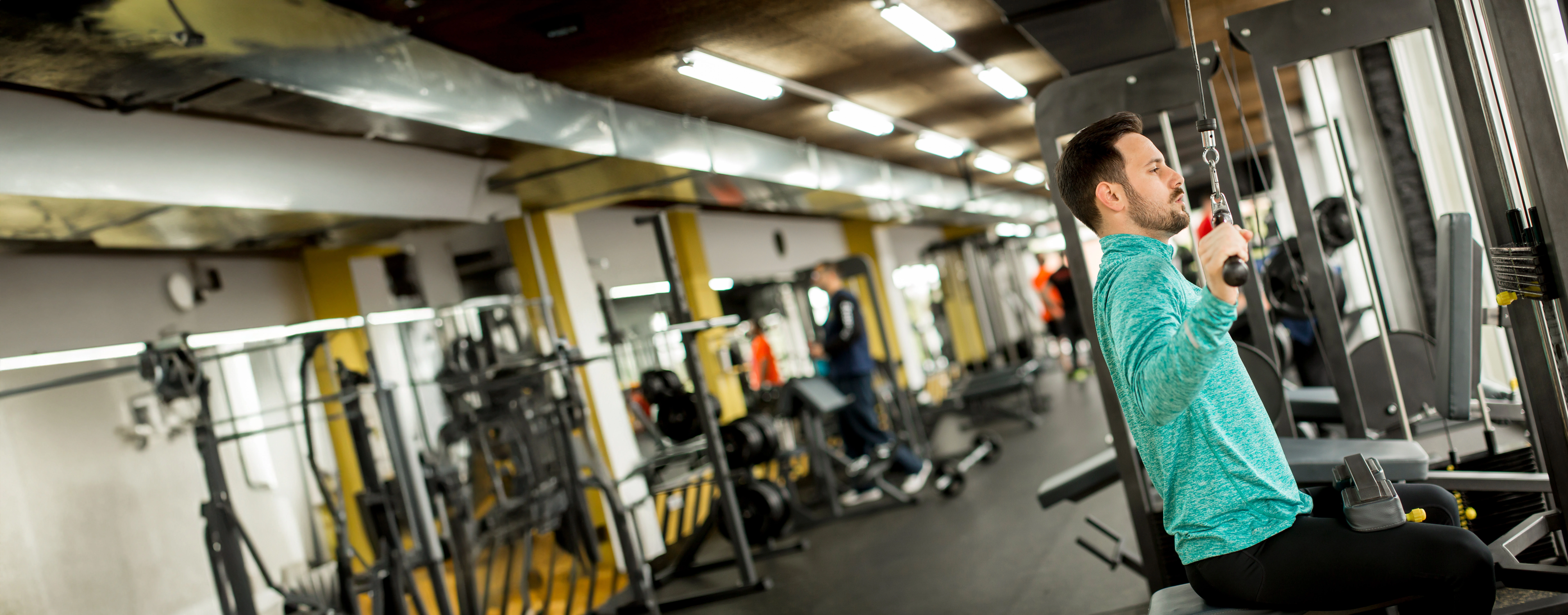 man-doing-excersise-on-a-lat-machine-in-gym.webp man-doing-excersise-on-a-lat-machine-in-gym.webp
